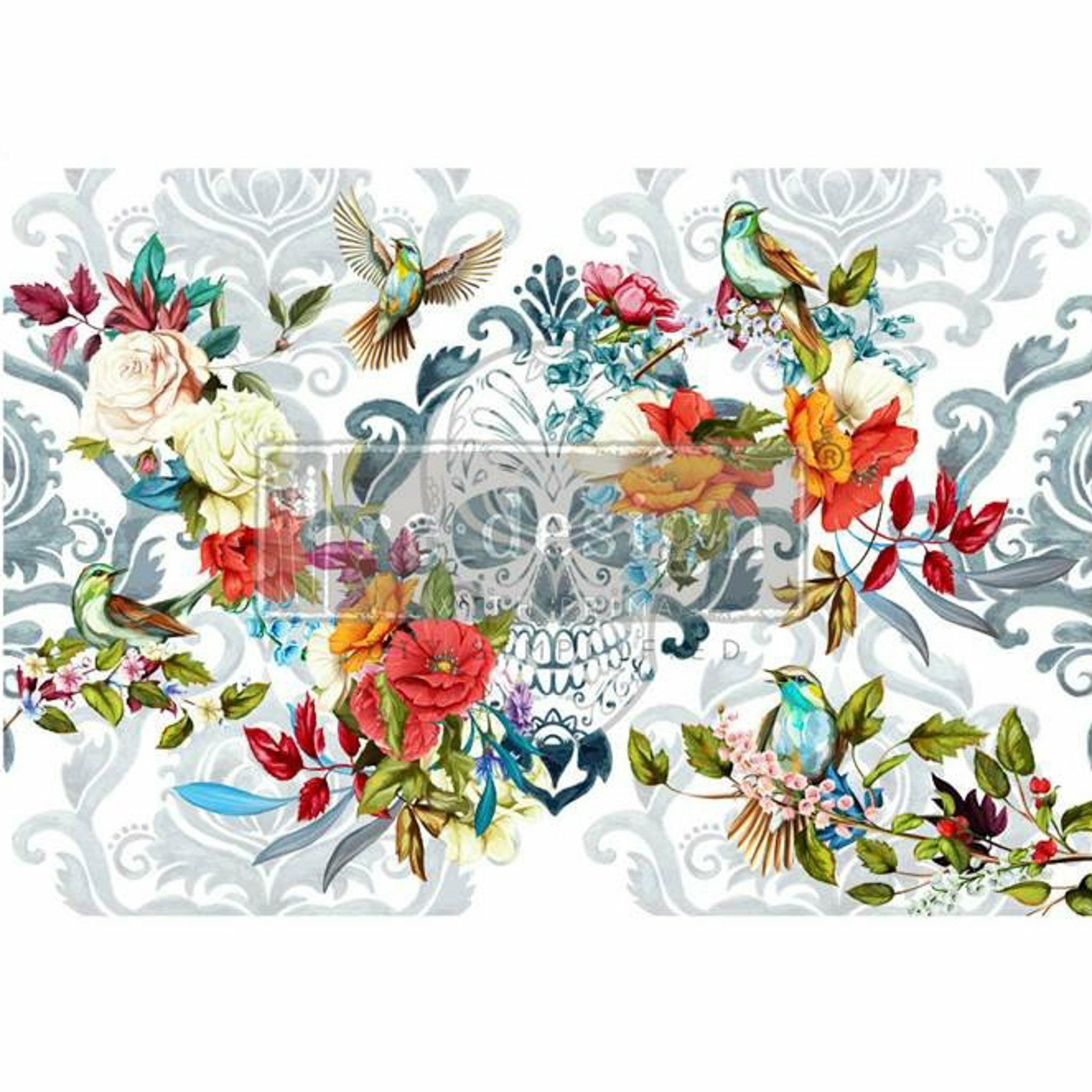 A rub on transfer featuring a sugar skull, vibrant flowers and birds, and a subtle grey floral damask background is against a white background.