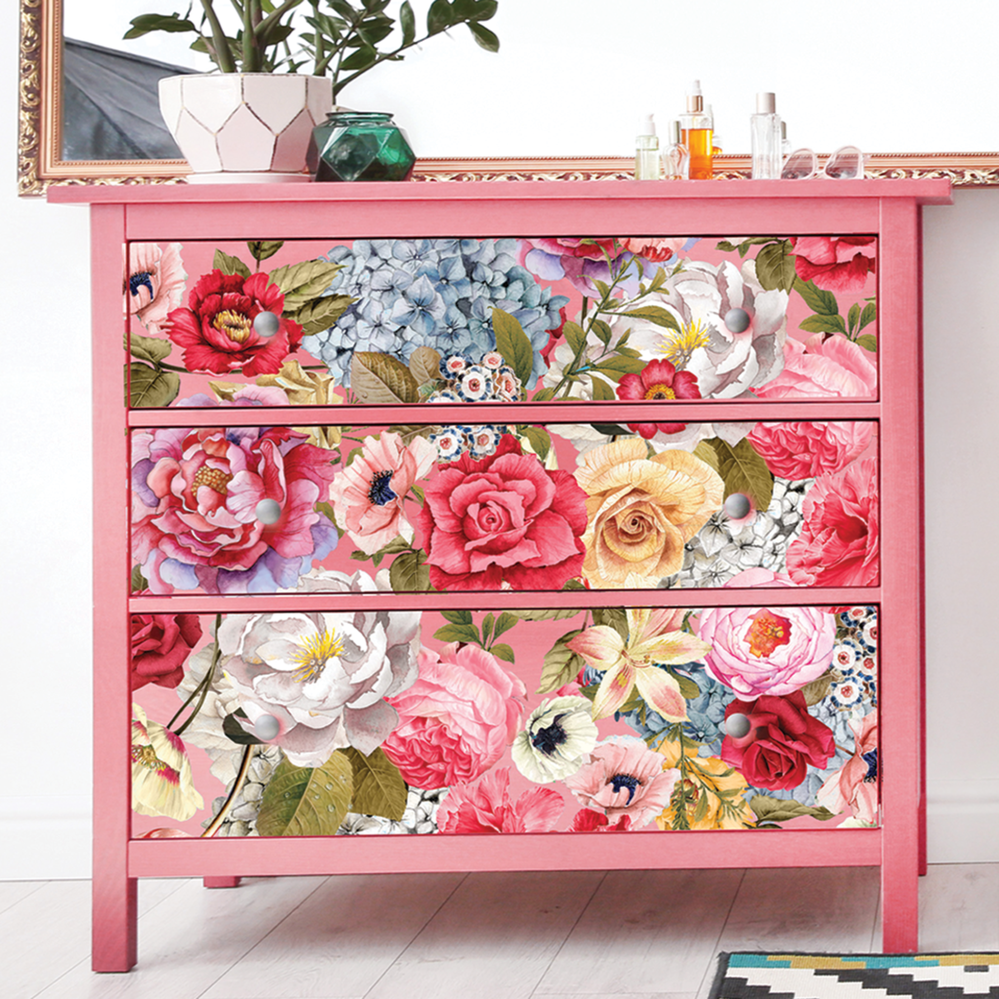 A 3-drawer dresser is painted soft pink and features ReDesign with Prima's Wondrous Floral 2 transfer covering all 3 drawers.