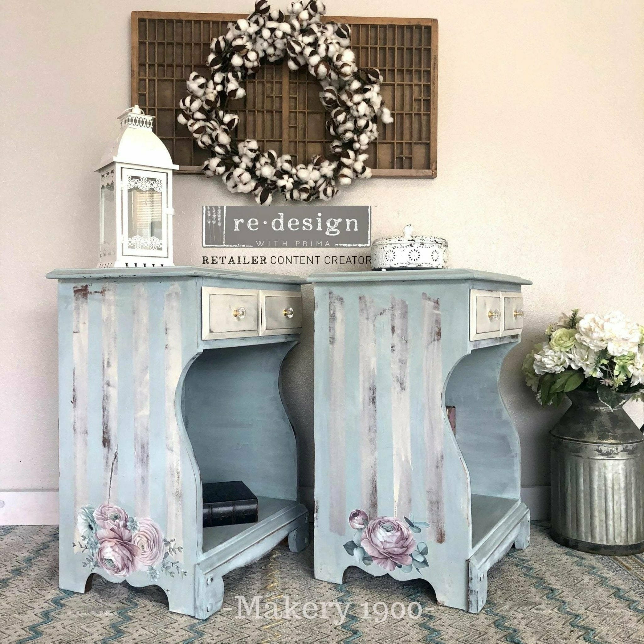 Two vintage nightstands refurbished by Makery 1900 are painted pale blue with faint white stripes on the sides and features ReDesign with Prima's Overflowing Love transfer at the bottom of the stripes.