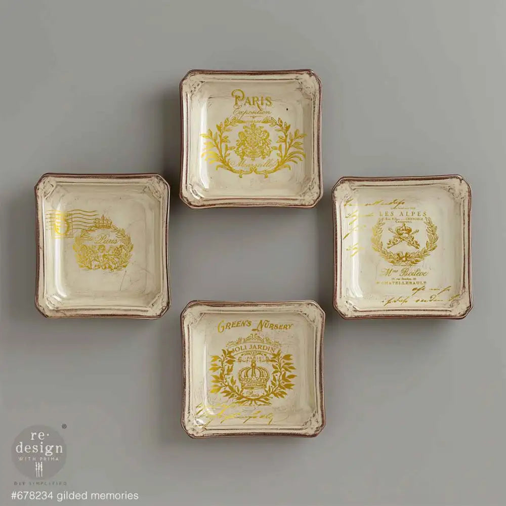 Four small vintage square plates feature ReDesign with Prima's Gilded Memories H2O Water Slide Transfers on them.