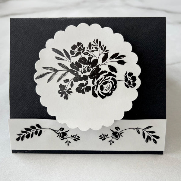 A card craft project is black and white and features the Blossomy H2O trasnfer on it. 