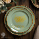 A large and small Tiffany blue colored plates with gold trim are on a decorated wood table. The small plate features ReDesign with Prima's Gilded Memories H2o Water Slide Transfers on it.