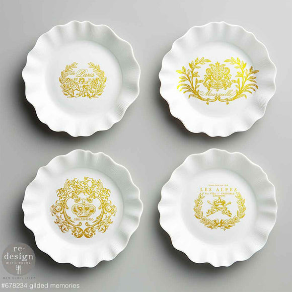 Four small white frill edged bowls feature ReDesign with Prima's Gilded Memories H2O Water Slide Transfers in them.