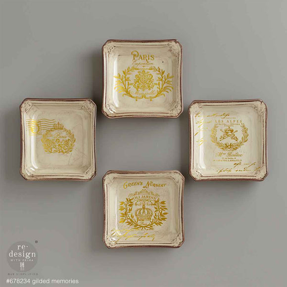 Four small vintage square plates feature ReDesign with Prima's Gilded Memories H2O Water Slide Transfers on them.