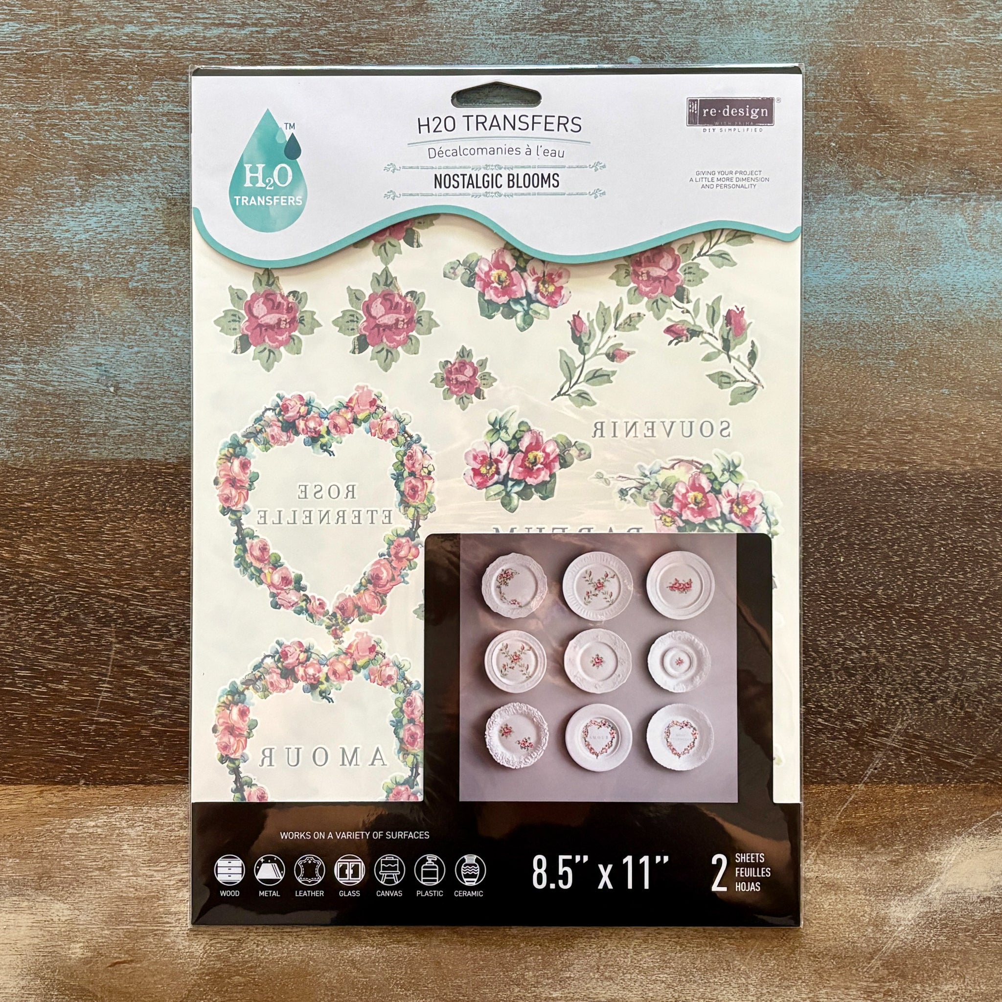 A package of ReDesign with Prima's Nostalgic Blooms H2O water transfers is against a wood background.