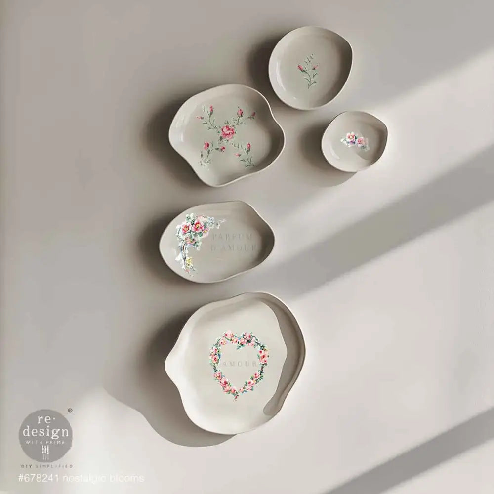 Five uniquely shaped varying size white bowls feature ReDesign with Prima's Nostalgic Blooms H2O Water Transfers inside the bowls.