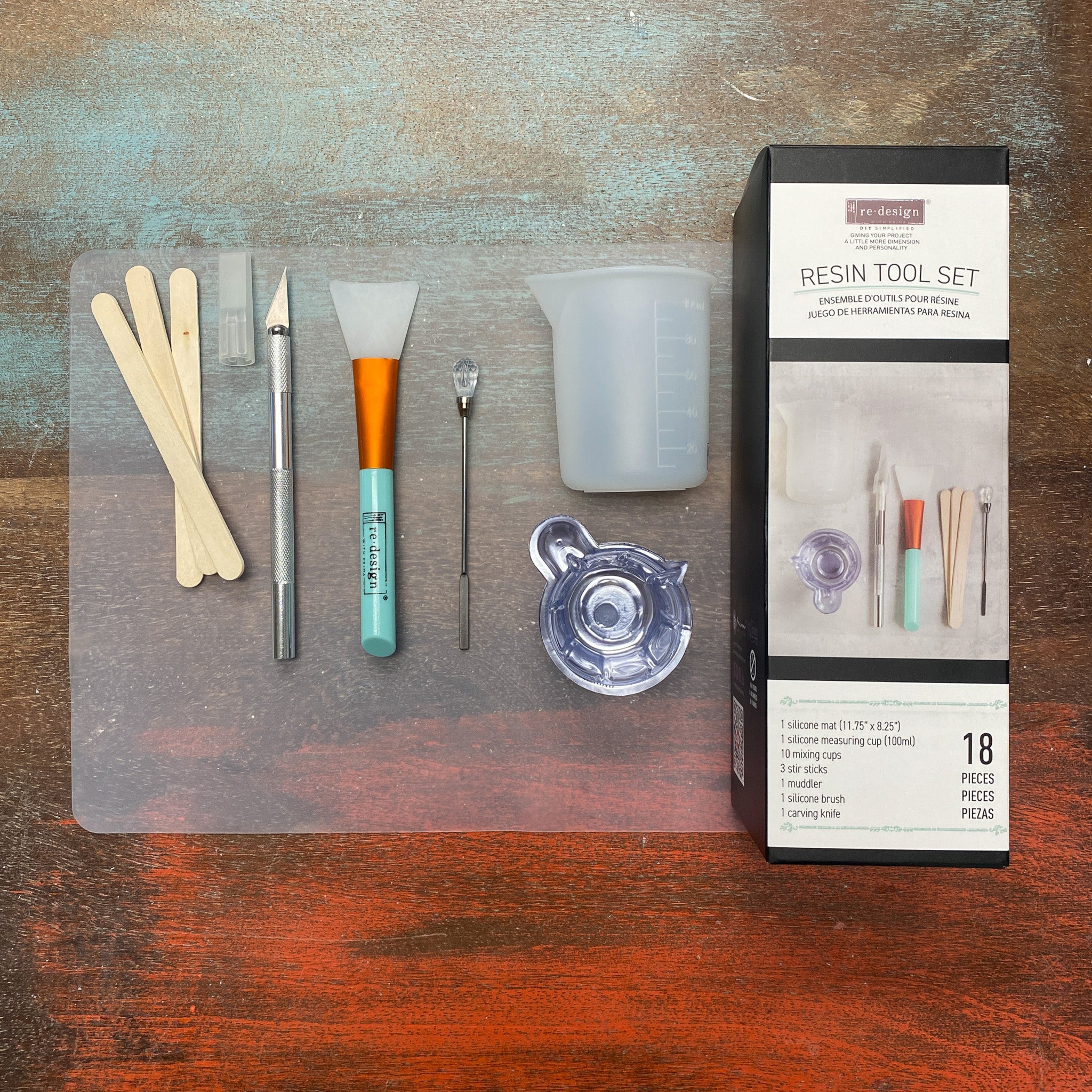 Resin tool set with tools and packaging on a wooden surface