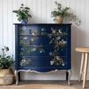 A vintage 4-drawer chest dresser is painted navy blue and features ReDesign with Prima's Aviary Elegance rub-on furniture transfer on the drawers.