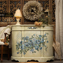 A vintage oval buffet cabinet refurbished by Lotus Theory Designs is painted soft beige and features ReDesign with Prima's Azure Blossom rub-on transfer on the front.