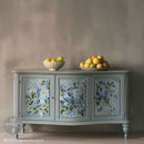 A vintage buffet cabinet is painted soft blue and features ReDesign with Prima's Azure Blossom large rub-on transfer on its 3 doors.