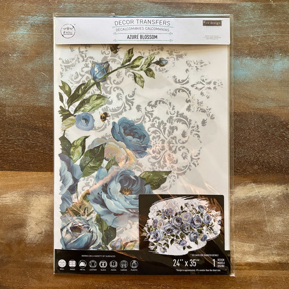 A package of ReDesign with Prima's Azure Blossom Furniture Transfer is against a wood background.
