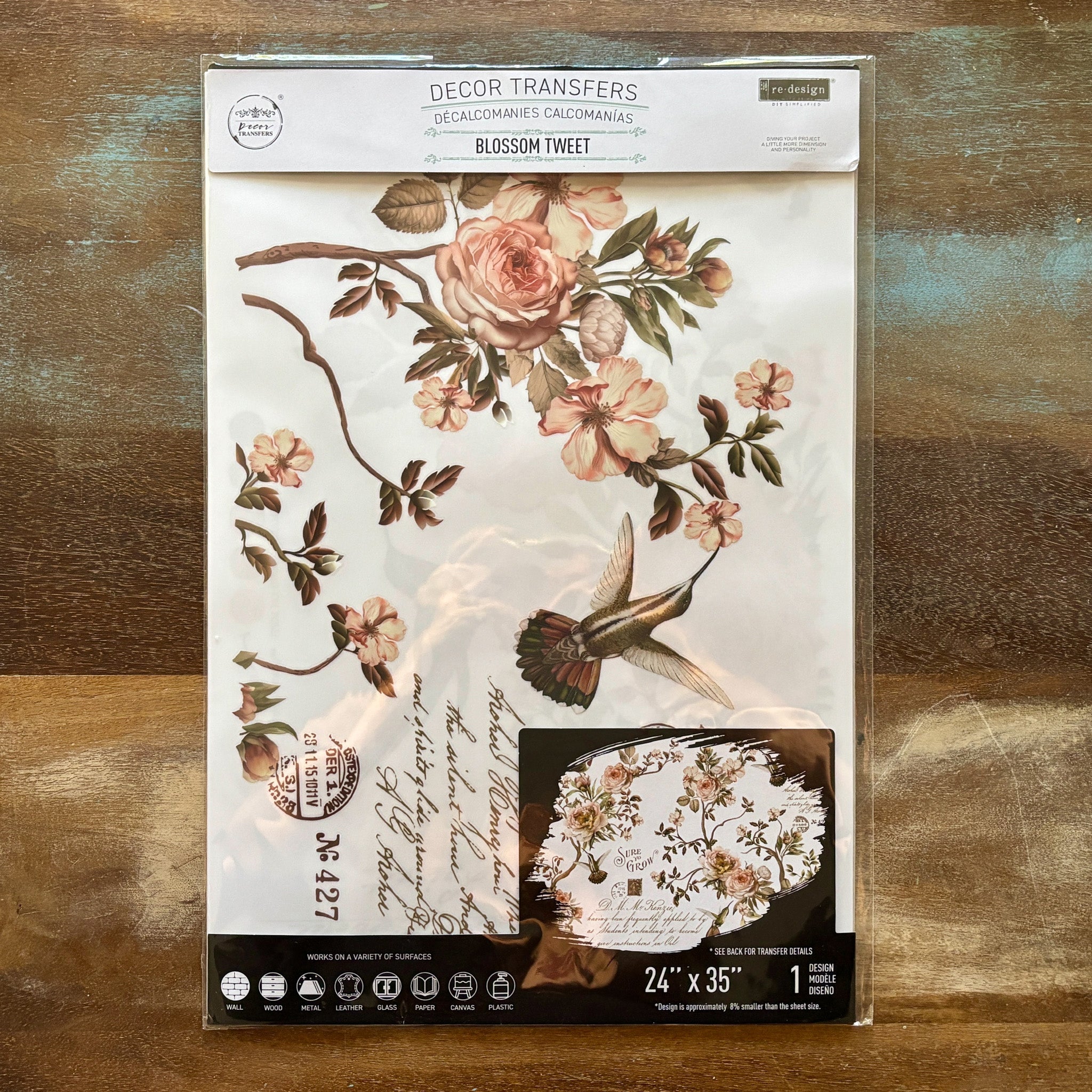 A package of ReDesign with Prima's Blossom Tweet Furniture Transfer is against a wood background.