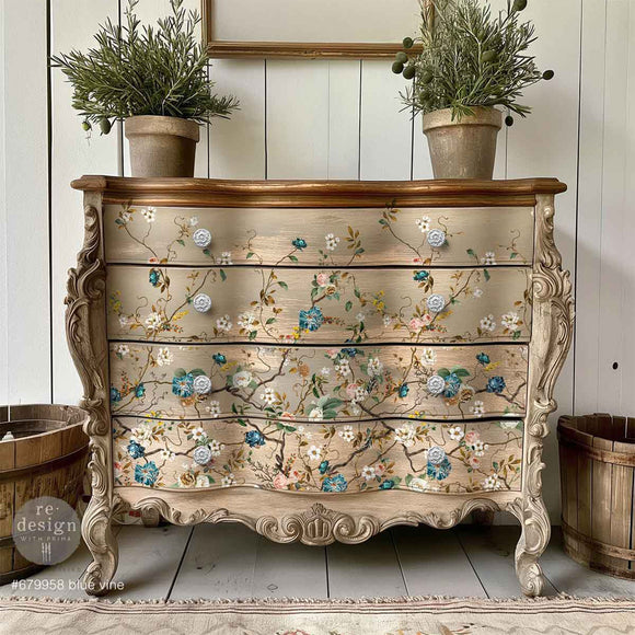 A vintage 4-drawer chest dresser is painted beige and features ReDesign with Prima's Blue Vine rub-on furniture transfer on it.
