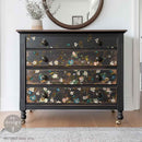 A vintage 4-drawer chest dresser is painted black and features ReDesign with Prima's Blue Vine rub-on transfer on the drawers.