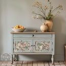 A small buffet hutch is painted grey and features ReDesign with Prima's Blush Blossoms small rub-on transfers on its 2 doors.