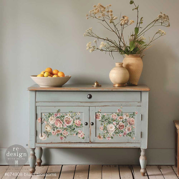 A small buffet hutch is painted grey and features ReDesign with Prima's Blush Blossoms small rub-on transfers on its 2 doors.