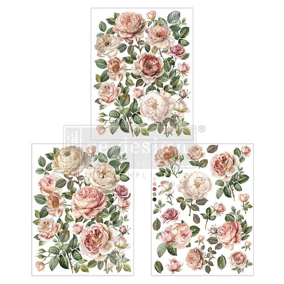 Three sheets of small rub-on transfers featuring cream and blush roses amidst whimsical greenery are against a white background.