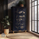 A vintage 6-drawer chest dresser is painted dark blue with gold details and features ReDesign with Prima's Branch Harmony rub-on furniture transfer on the drawers.
