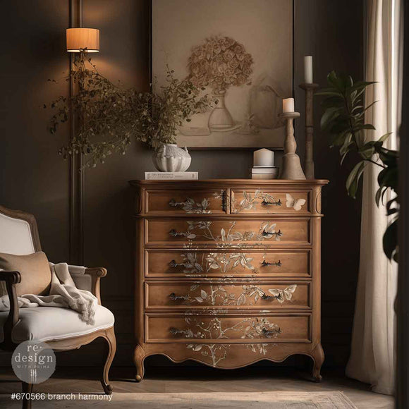 A natural wood 6-drawer chest dresser features ReDesign with Prima's Branch Harmony rub-on furniture transfer on the front.