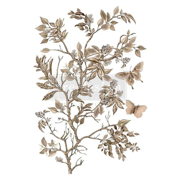 A rub-on transfer featuring delicate tan flowering branches surrounded by fluttering butterflies is against a white background.