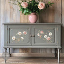 A vintage console table with storage is painted grey and features ReDesign with Prima's Creamy Blush Blooms small rub-on transfers on its 2 doors.