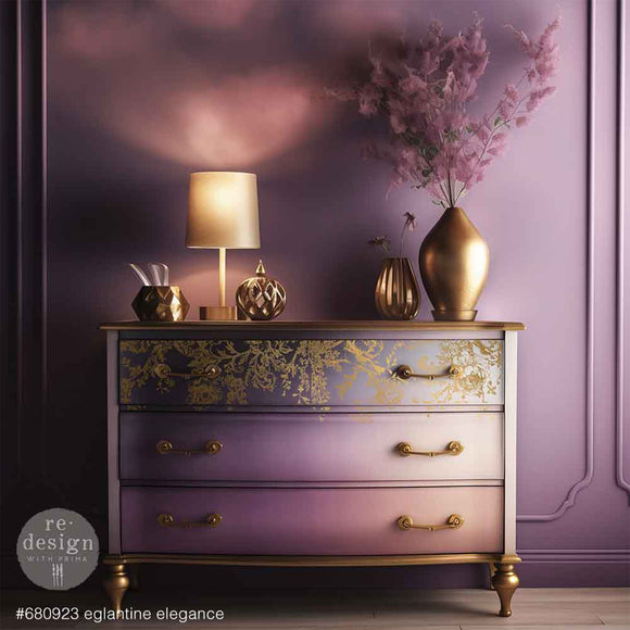 Decorative dresser with gold accents and a lamp against a purple wall.