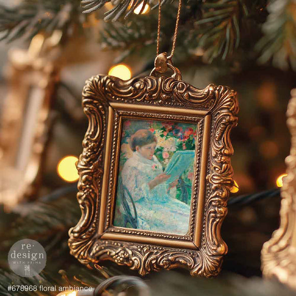 Decorative ornament with vintage frame and painting inside, hanging on a tree.
