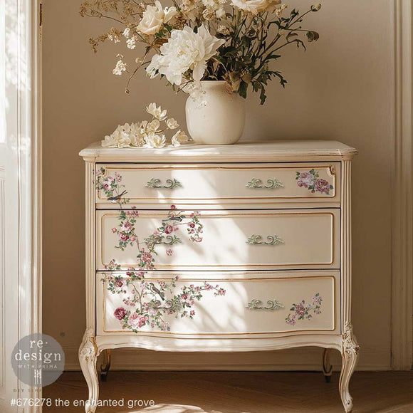 A vintage 3-drawer dresser is painted off-white and features ReDesign with Prima's Kacha The Enchanted Grove small rub-on transfers on the front.