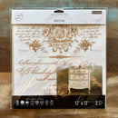 A package of ReDesign with Prima's Queen's Glory 12"x12" rub-on transfers are against a wood background.