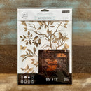 A package of ReDesign with Prima's Quiet Contemplation middy rub-on transfers is against a wood background.