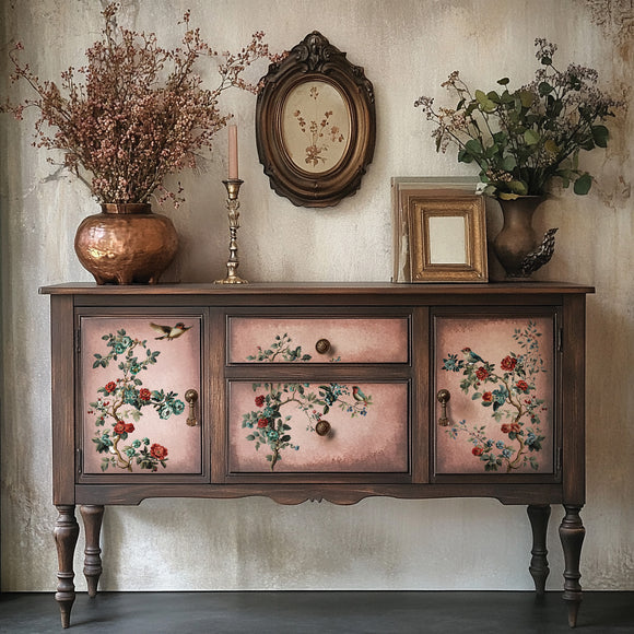 Decorative wooden sideboard with floral designs on doors, placed against a neutral wall with decorative elements.