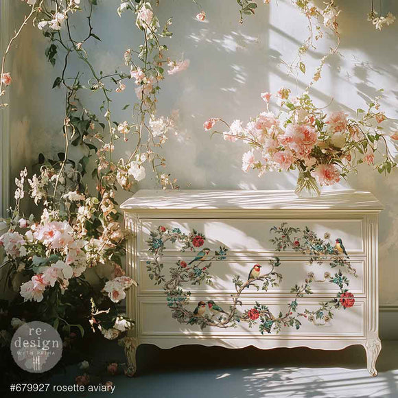 Decorative chest of drawers with floral and bird patterns, surrounded by flowers.