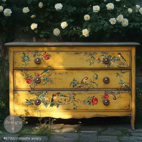 Yellow dresser with floral and bird designs with white flowers in the background