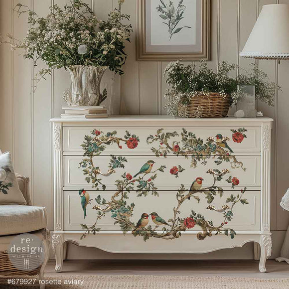 Decorative chest of drawers with floral and bird design in a room setting.