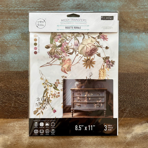 A package of ReDesign with Prima's Rosette Royale middy rub-on transfers is against a wood background.