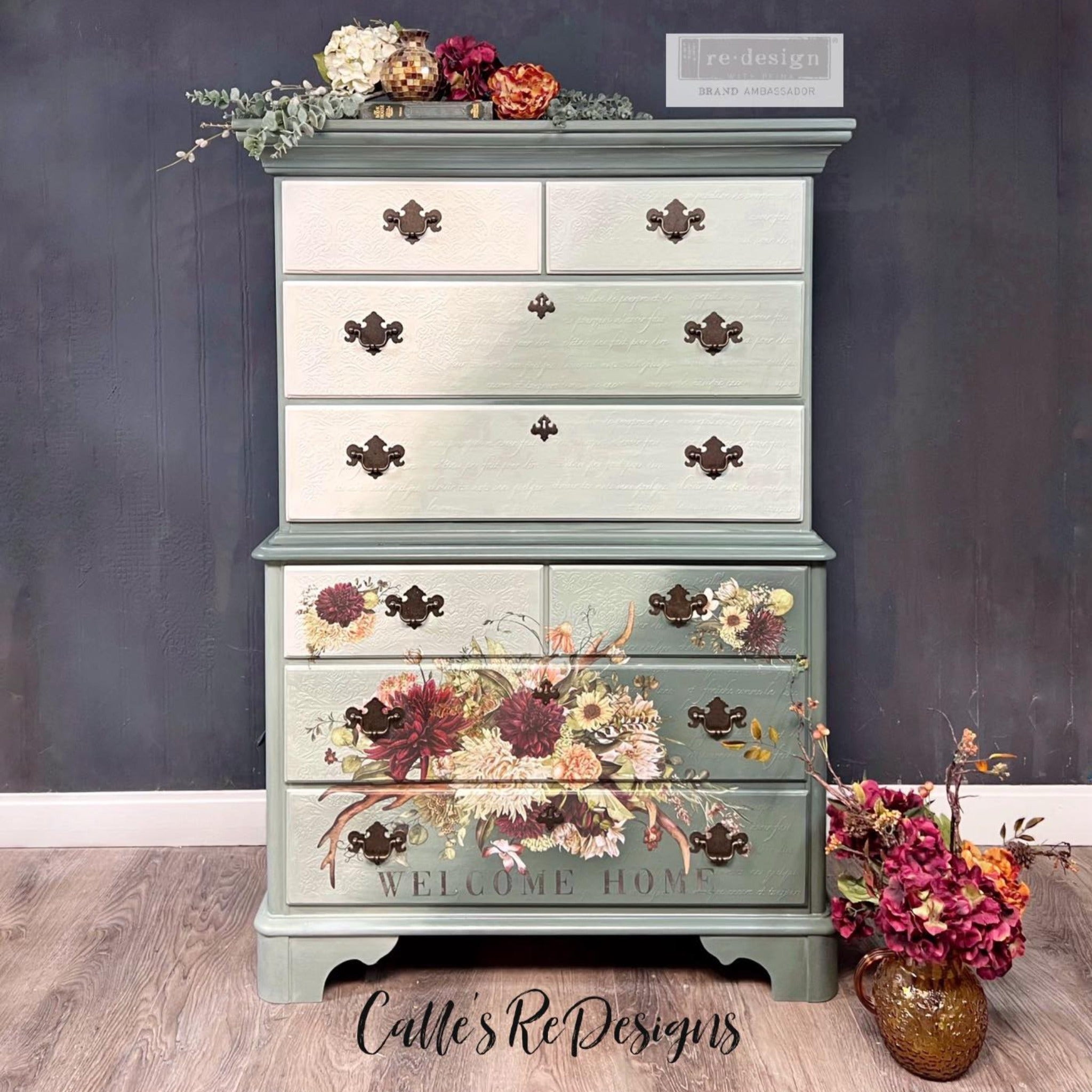 A vintage 8-drawer dresser refurbished by Calle's ReDesigns is painted an ombre of light and sage green and features ReDesign with Prima's Rustic Charm furniture transfer on its bottom 4 drawers.