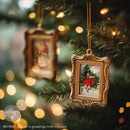 Decorative Christmas ornament with a gold frame and festive design, hanging on a tree with blurred lights in the background.