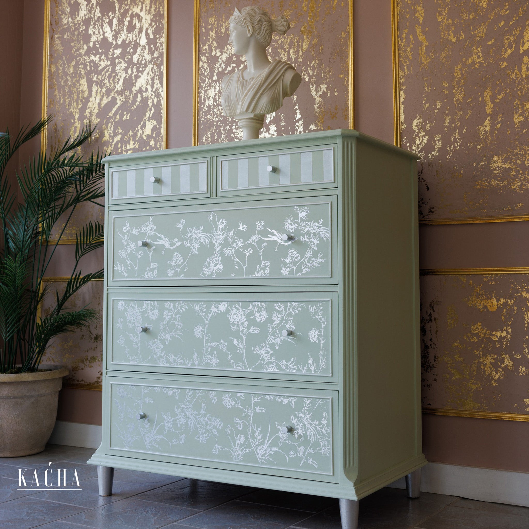 A vintage 5-drawer dresser is painted mint green and features ReDesign with Prima's Kacha Silver Bird Silver Foil rub-on transfer on the 3 large bottom drawers.