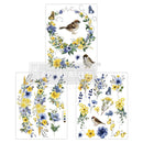 Three sheets of small rub-on transfers featuring yellow and blue floral garlands and wreaths, birds, and butterflies are against a white background.
