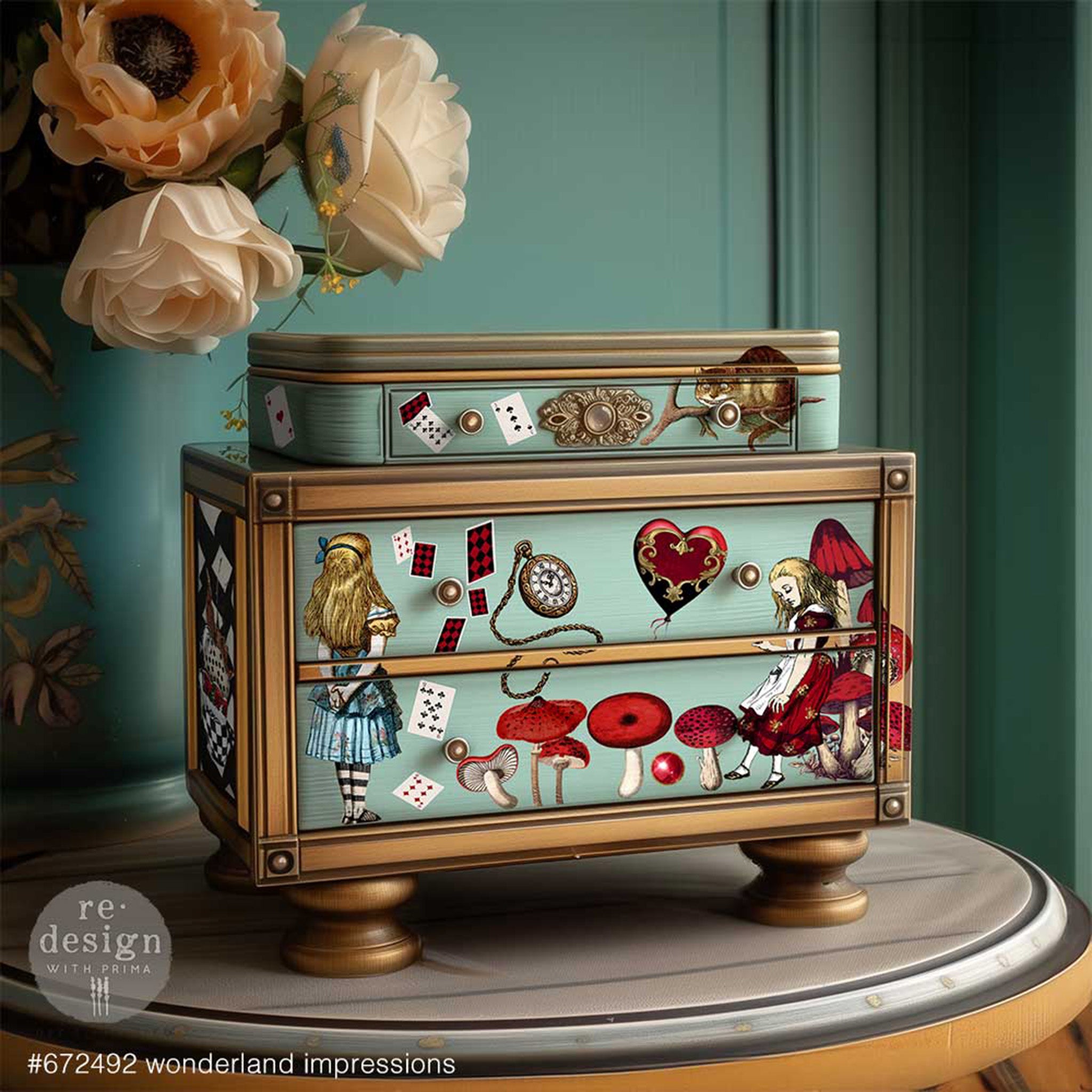 A small wood jewelry box is painted pale teal with bronze accents and features ReDesign with Prima's Wonderland Impressions middy transfers on it.