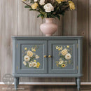 A vintage console table with storage is painted grey and features ReDesign with Prima's Yellow Bliss small rub-on transfers on its 2 door inlays.