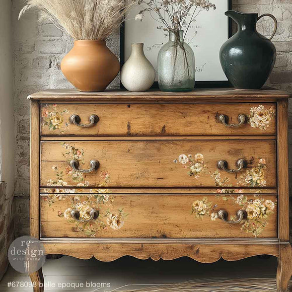 A natural wood 3-drawer dresser features ReDesign with Prima's Belle Epoque Blooms middy rub-on transfers on the drawers.