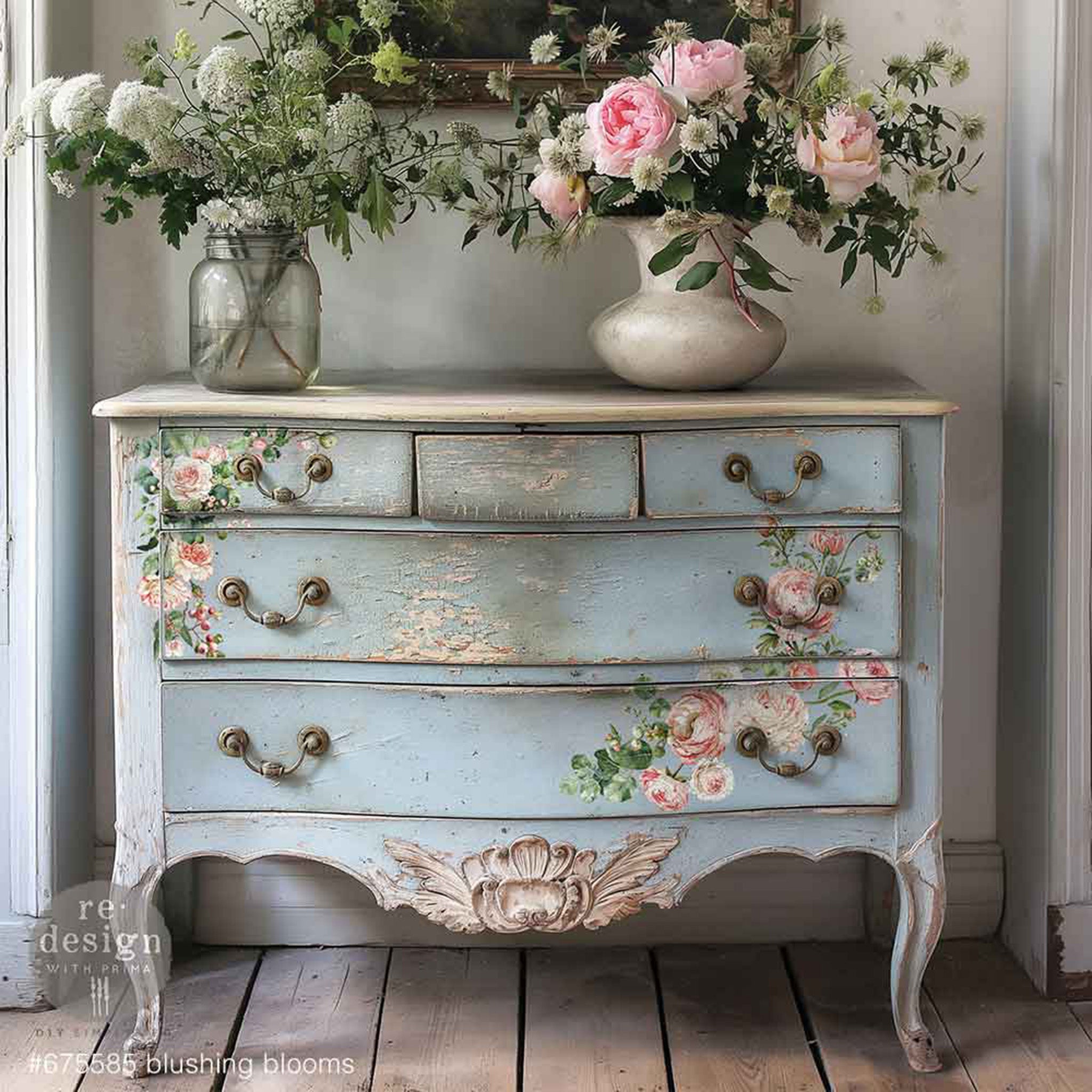 A vintage 5-drawer dresser is painted pale blue and features ReDesign with Prima's Blushing Blooms small rub-on transfers on the drawers.