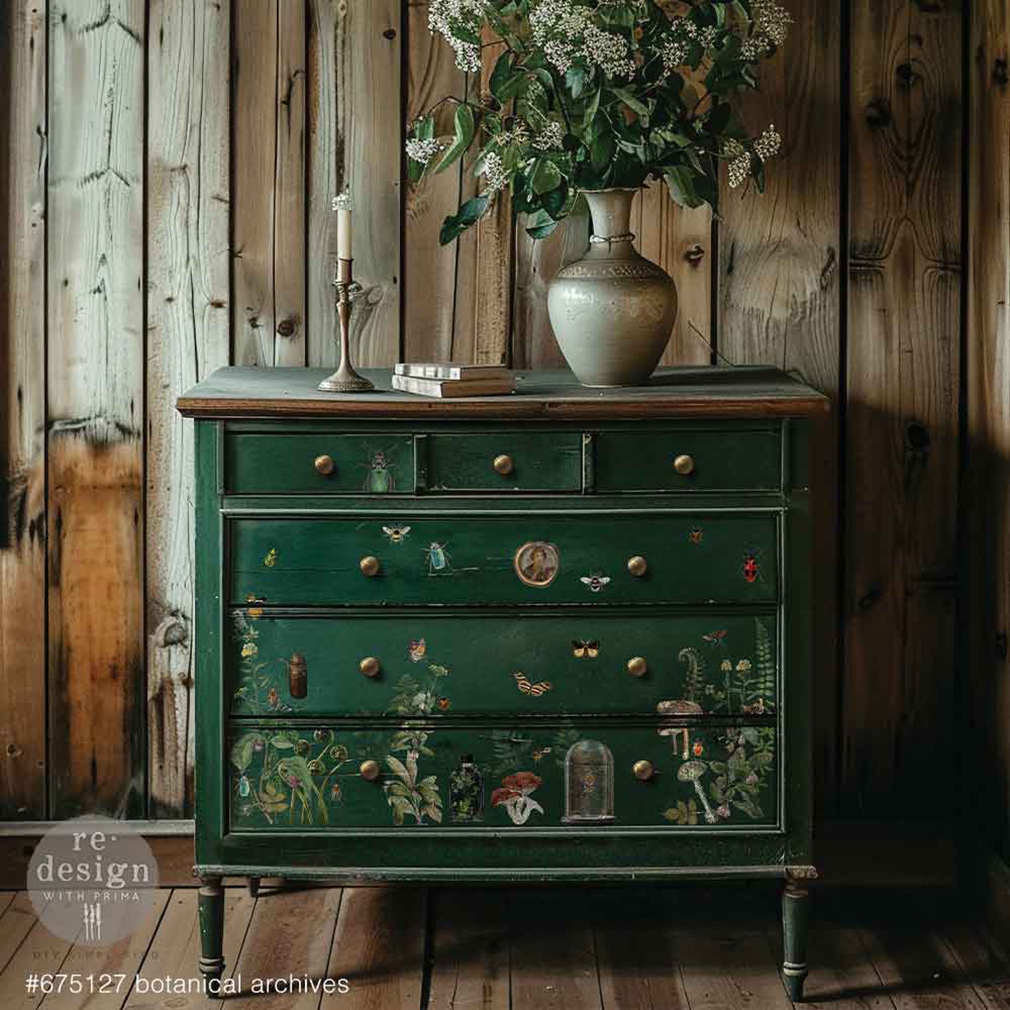 A 6-drawer dresser is painted dark green and features ReDesign with Prima's Botanical Archives small rub-on transfers on the bottom 3 large drawers.