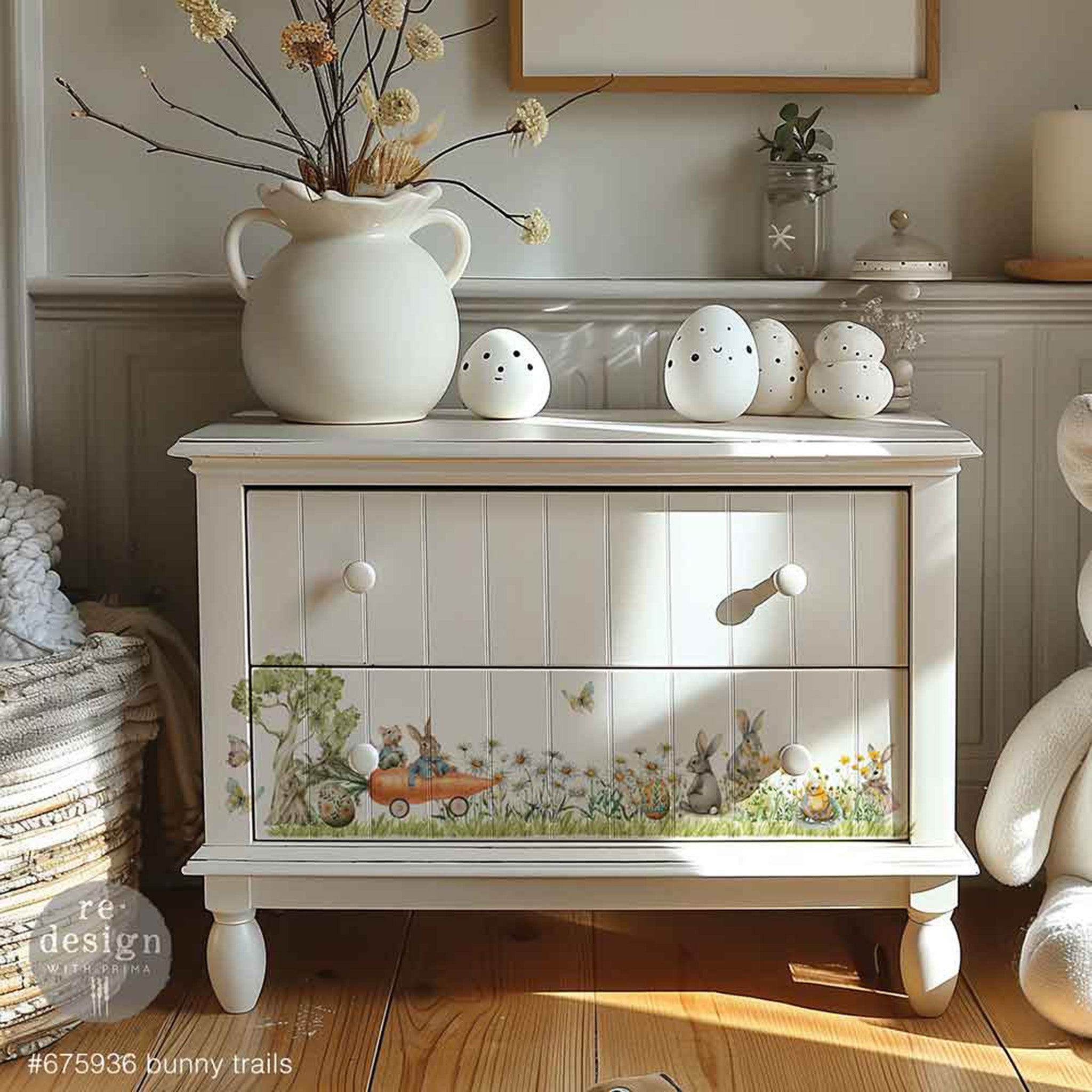 A white painted country style 2-drawer dresser features ReDesign with Prima's  Bunny Trails small rub-on transfers on the bottom drawer.