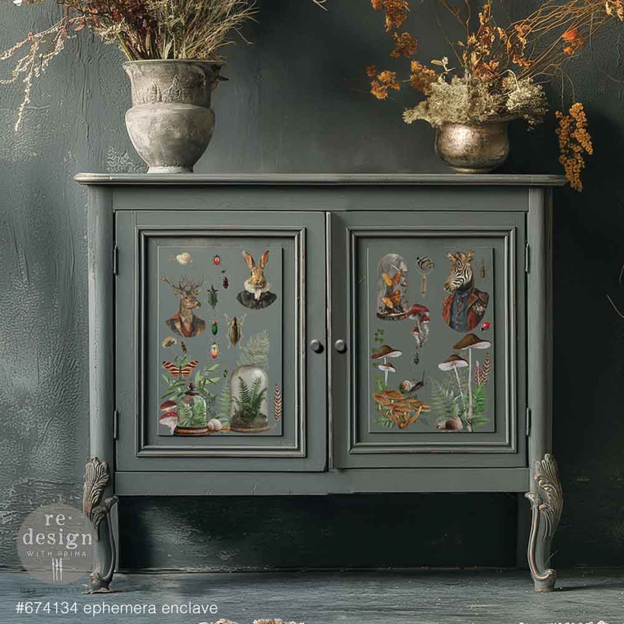 A vintage small bar cabinet is painted dark grey and features ReDesign with Prima's Ephemera Enclave small rub-on transfers on its 2 doors.