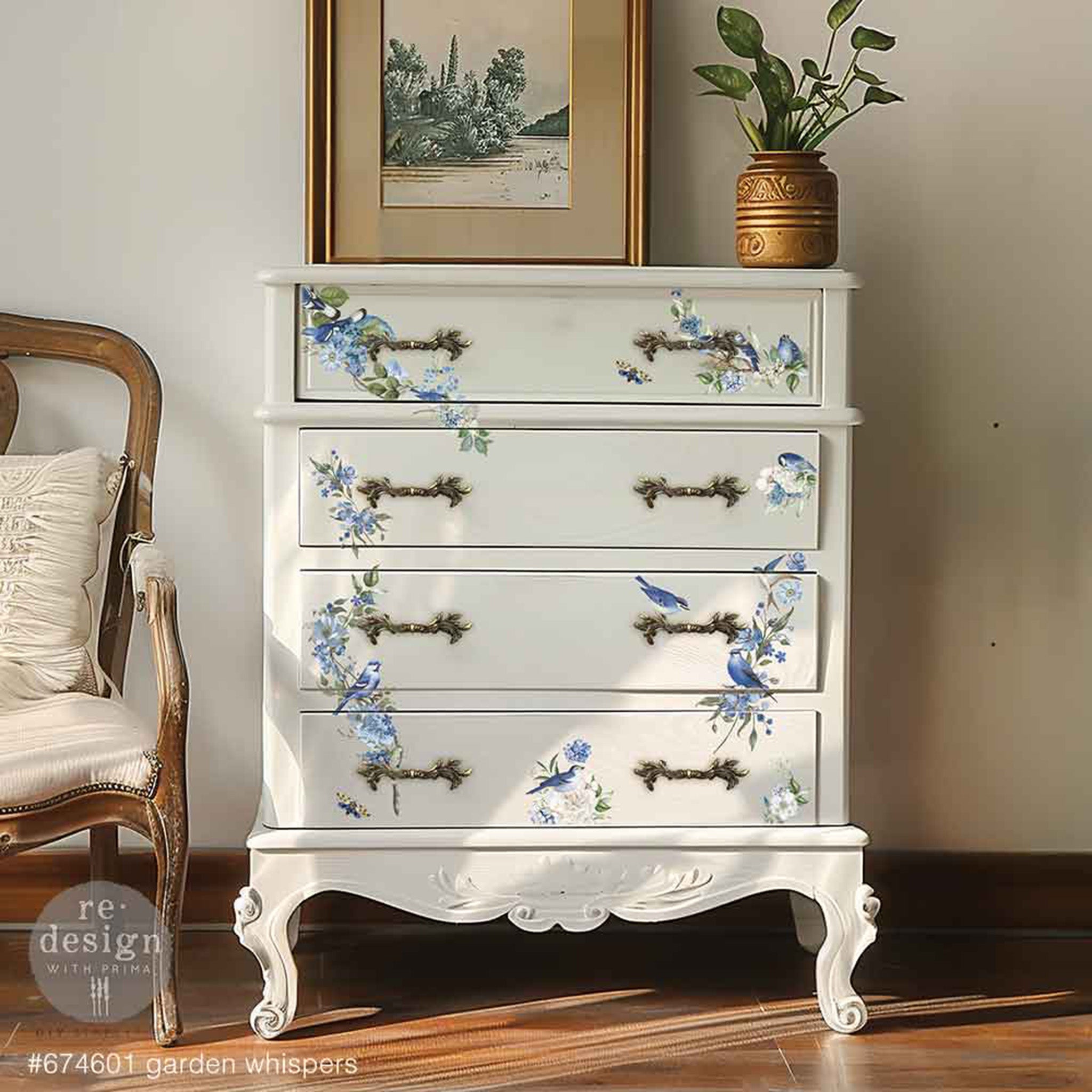 A vintage 4-drawer chest dresser is painted white and features ReDesign with Prima's Garden Whispers small rub-on transfers on the drawers. 