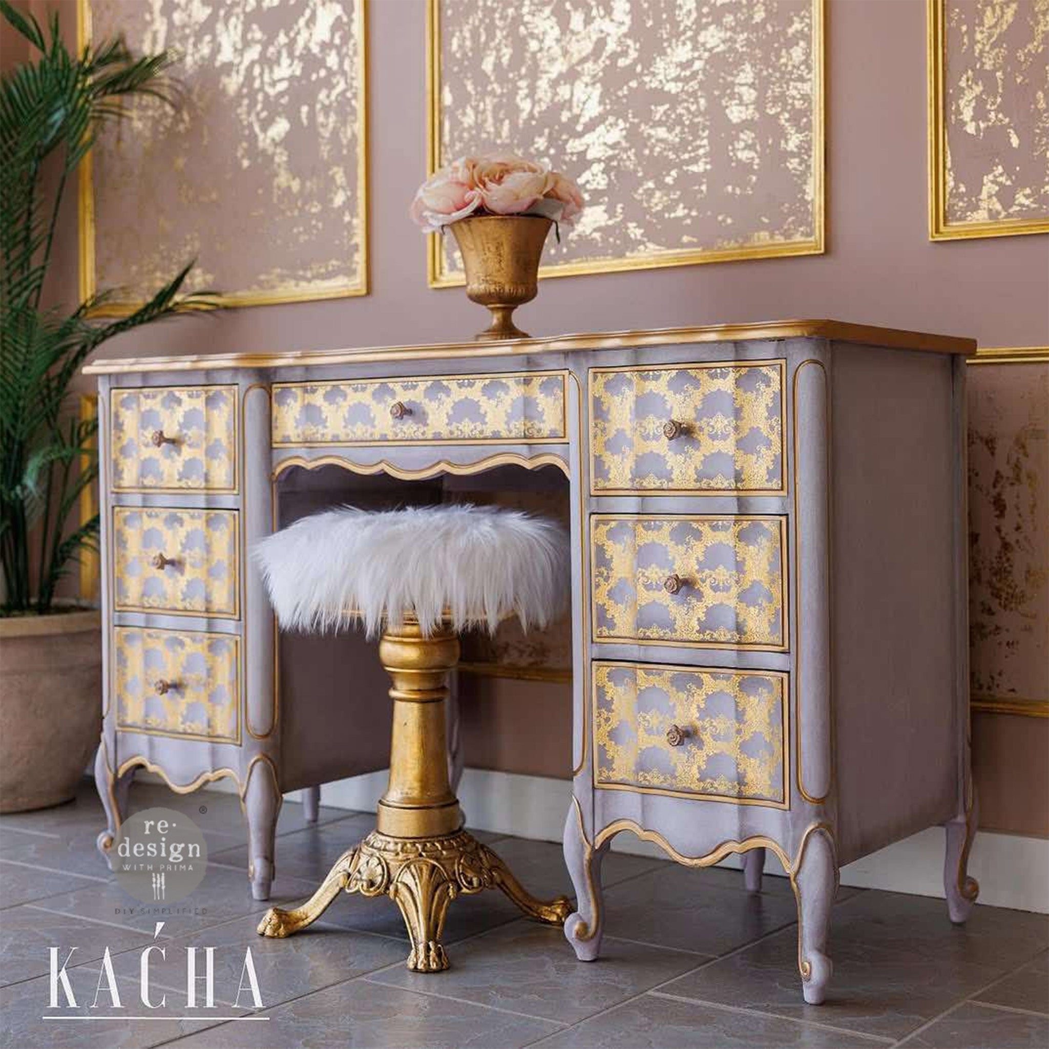 A vintage vanity desk refurbished by Kacha is painted pale pink with gold trim and features ReDesign with Prima's Kacha Golden Lacework gold foil furniture transfer on its 7 drawers.