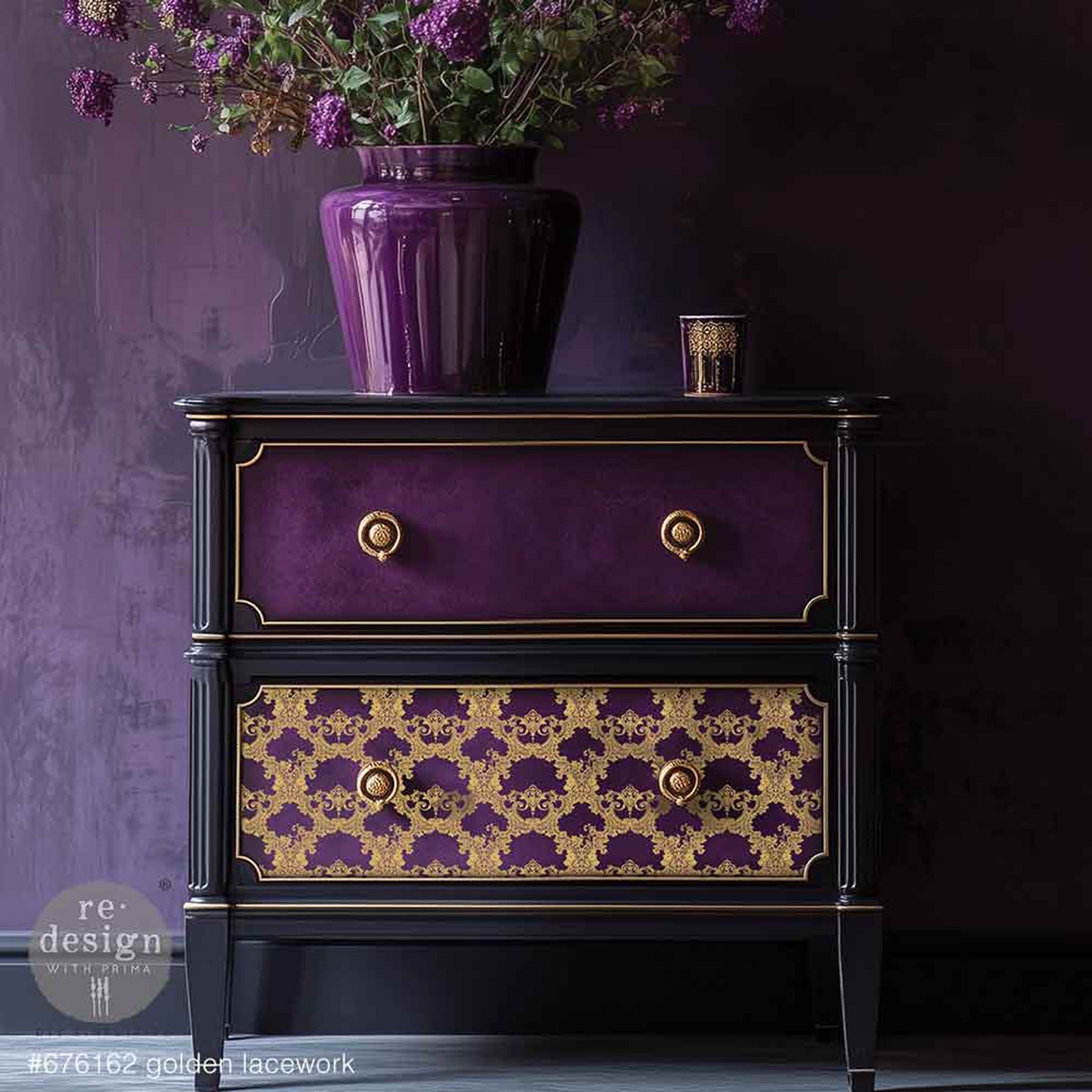 A vintage 2-drawer nightstand is painted black with dark purple drawers and gold accents and features ReDesign with Prima's Kacha Golden Lacework Gold Foil small transfer on the bottom drawer.