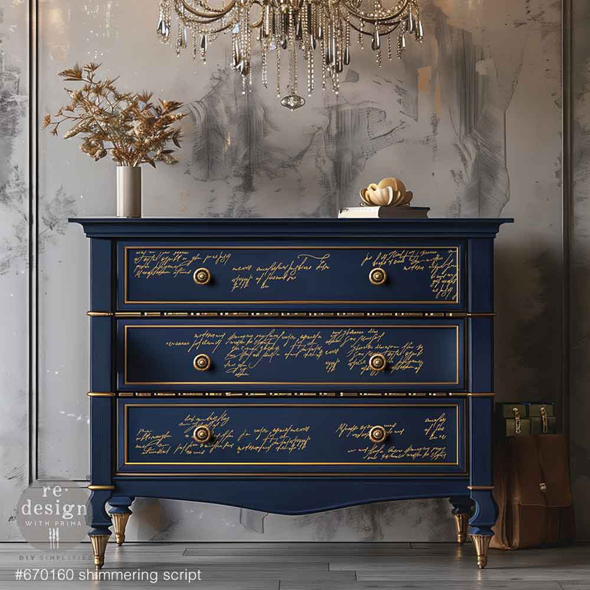 A vintage style 3-drawer dresser is painted navy blue with gold accents and features ReDesign with Prima's Kacha Shimmer Script Gold Foil small transfer on the drawers.